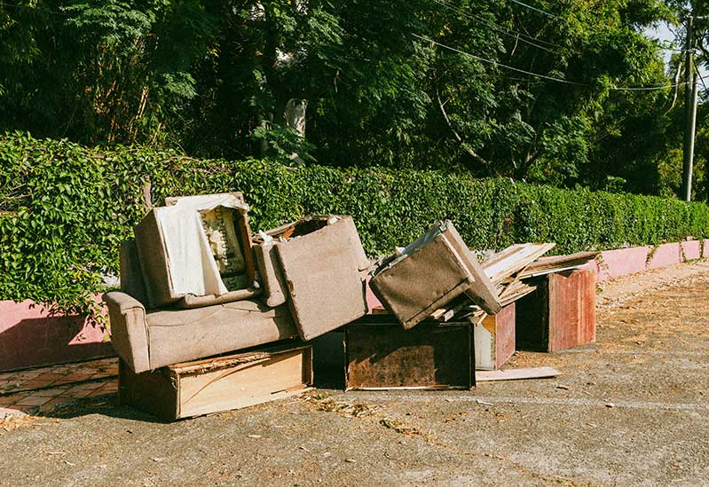 bulk trash sitting on the curb for disposal service pickup